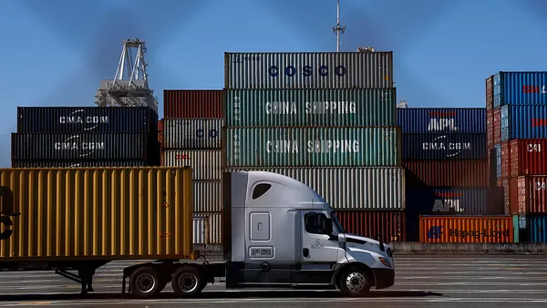 A truck drives through a port in Oakland, California.