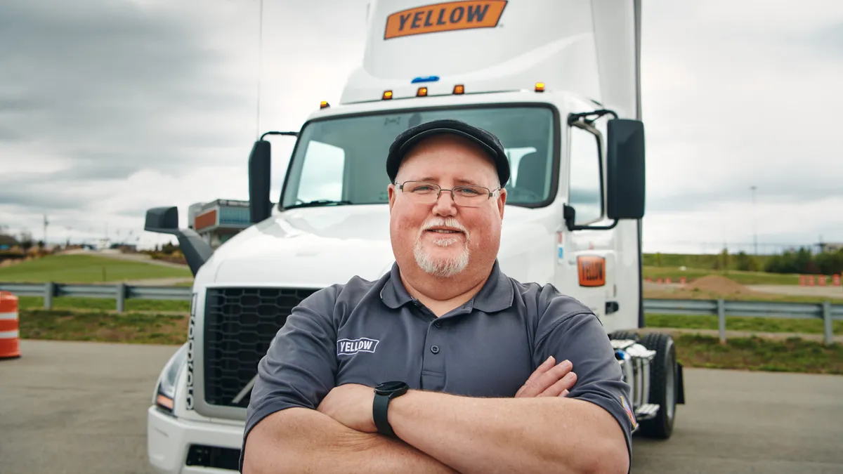 A company portrait of Rich Frazer, Yellow driver and training instructor, in front of a Yellow truck.