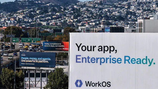 Various billboards speaking about AI companies can be seen over a busy highway.