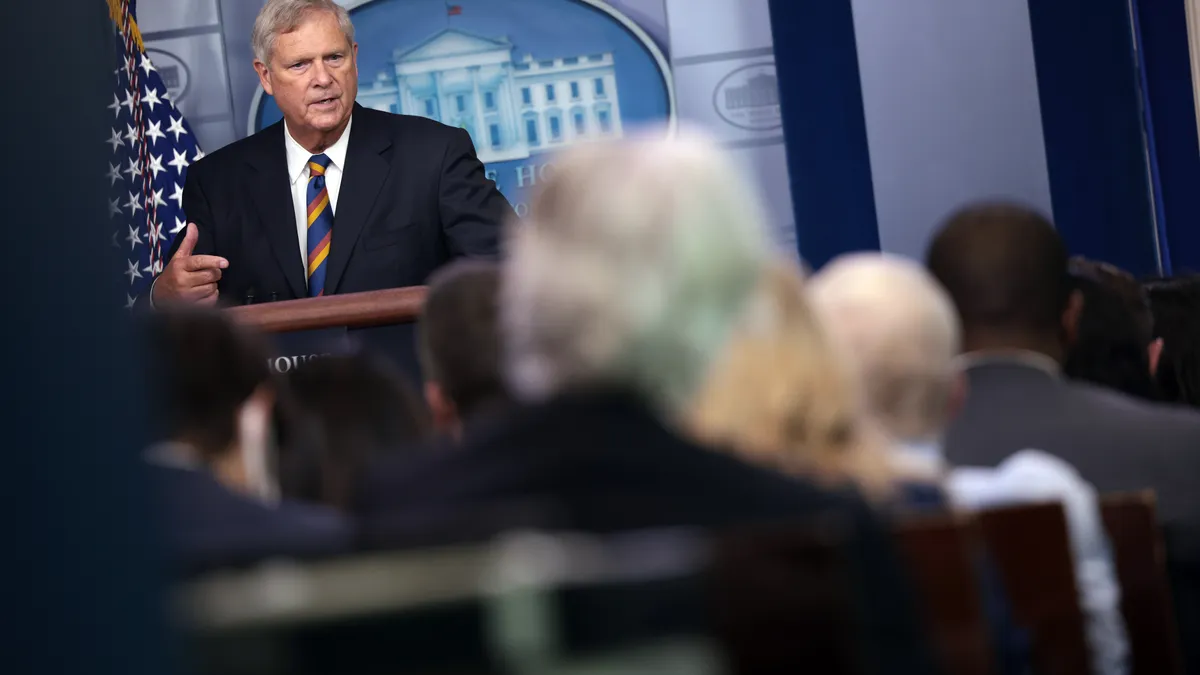 Agriculture Secretary Tom Vilsack speaks at a lectern.