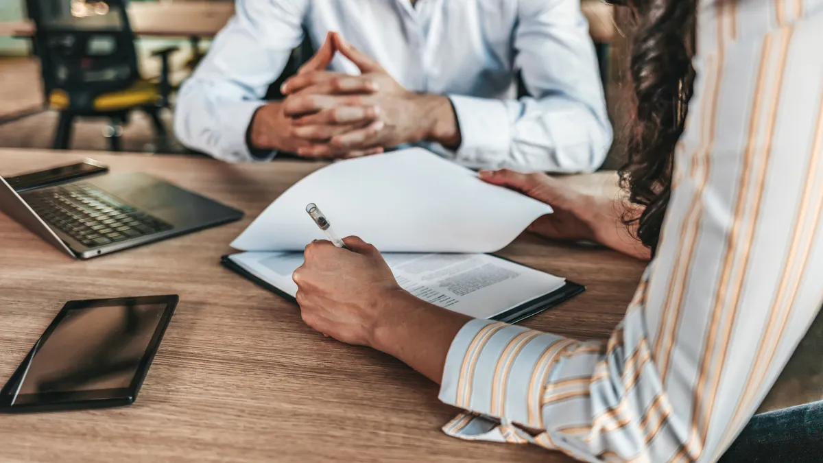 Female business person signs contract