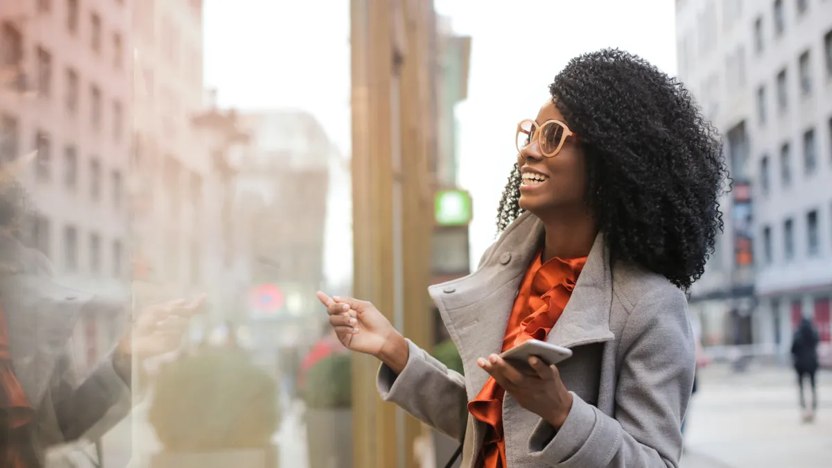 Happy woman laughing on street