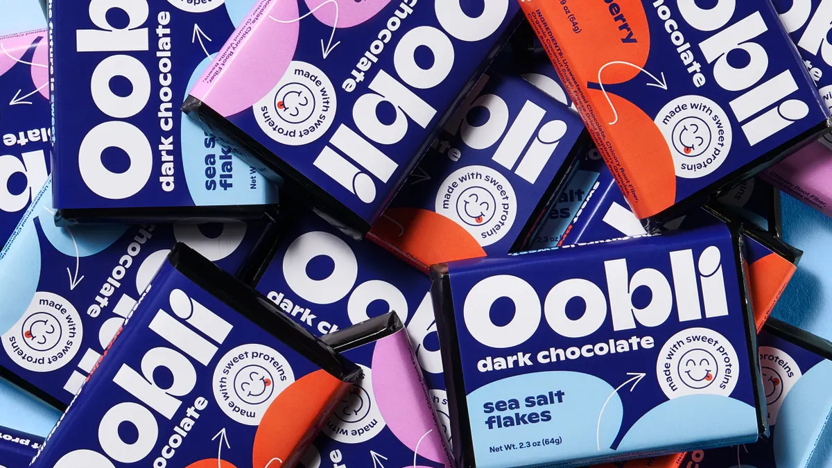 A pile of wrapped chocolate bars made by Oobli