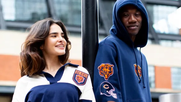 Two people wearing sports fan apparel.