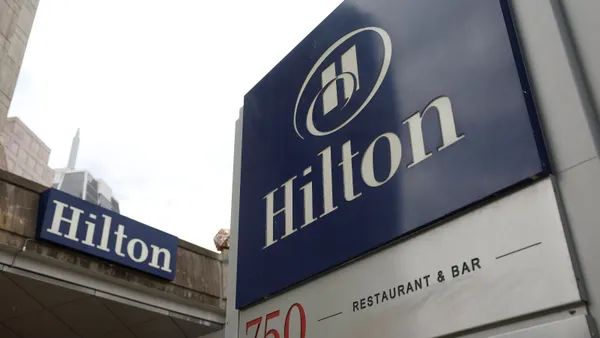 A sign is posted in front of a Hilton hotel on July 23, 2025 in San Francisco, California.