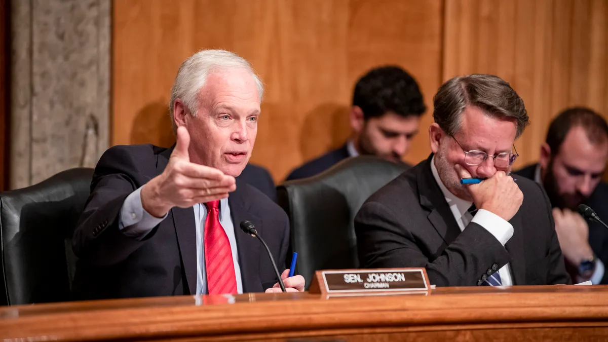 Senator Ron Johnson speaking behind a dais.