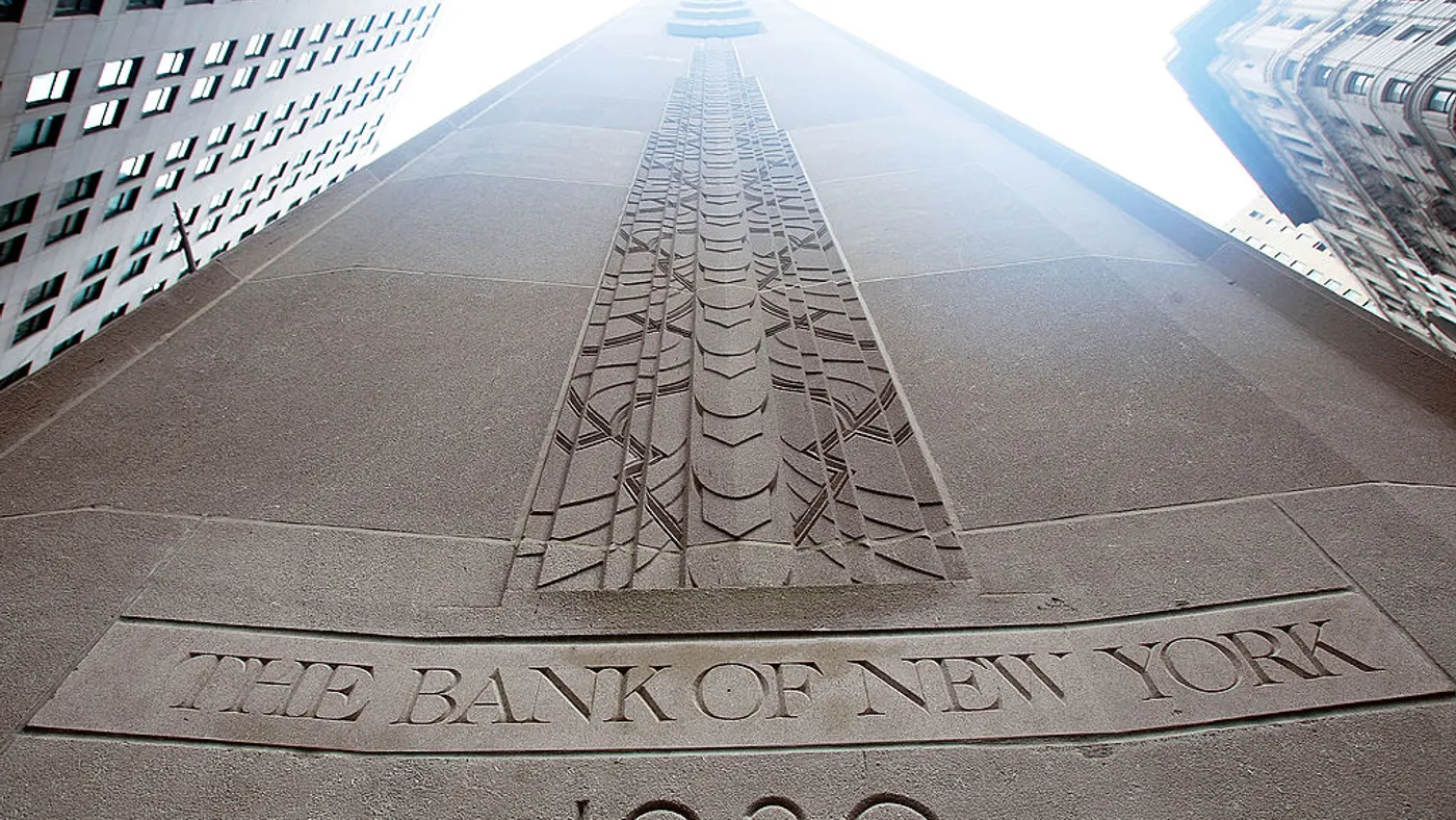 A stone building with the words "The Bank of New York" and "1930" inscribed is shown from below looking up.