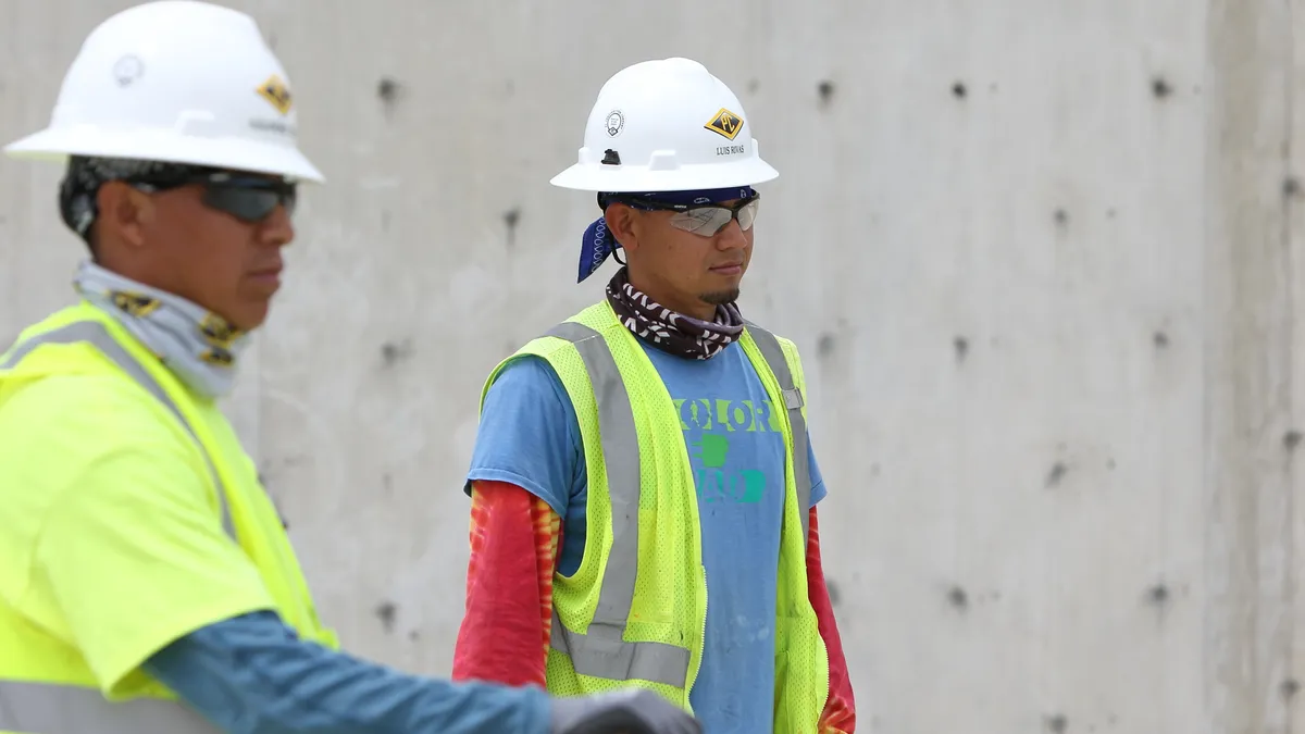 Two men of color on a construction site.