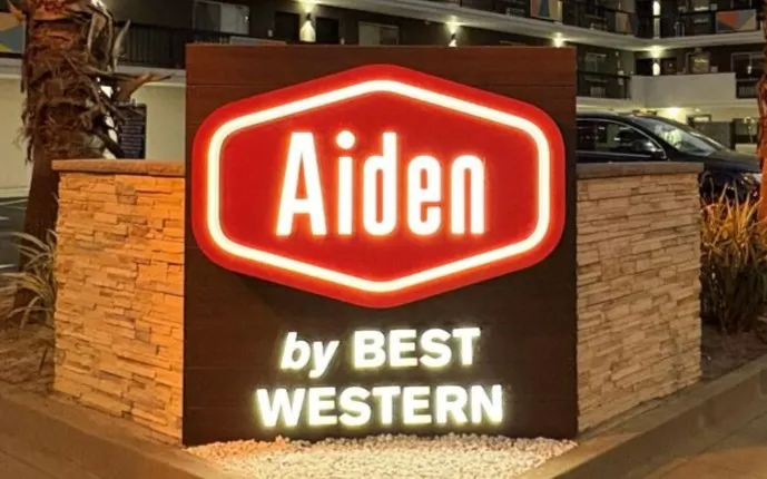 A sign shows BWH Hotels' Aiden brand logo.