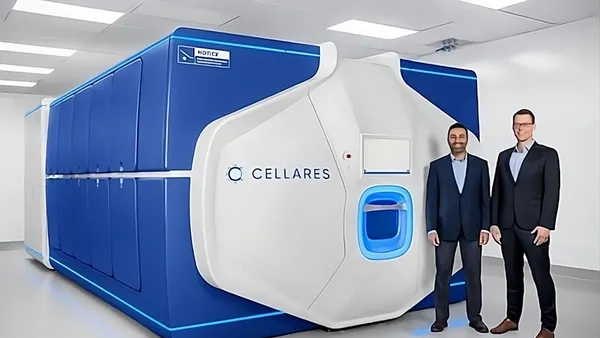 Two people in business suits stand next to a closed manufacturing pod emblazoned with the word Cellares.