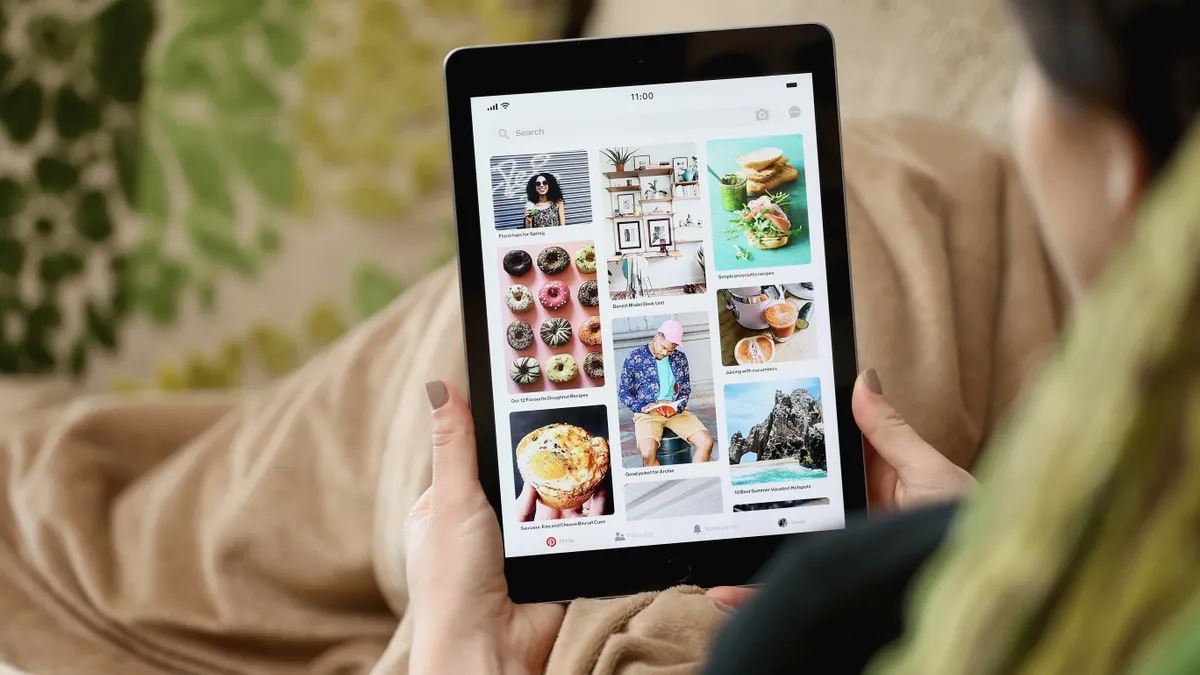 A person scrolls through Pinterest on an iPad.