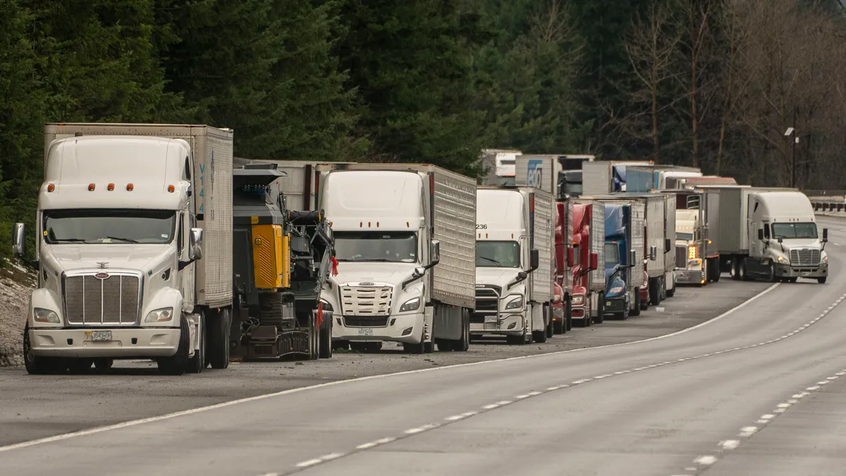 Trucks sit parked along Interstate 90 where the highway has been temporarily closed on January 8, 2022 in North Bend, Washington.