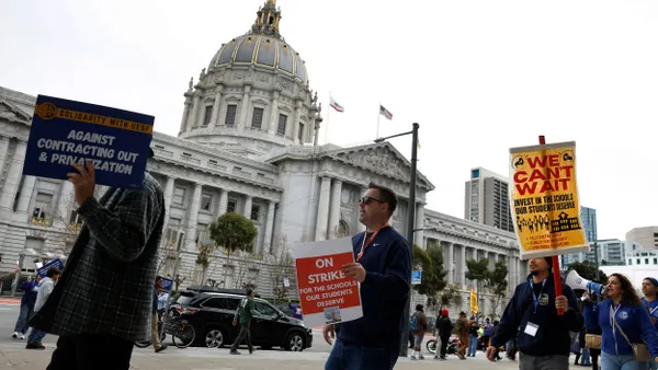 Teachers picket outside San Francisco City Hall.