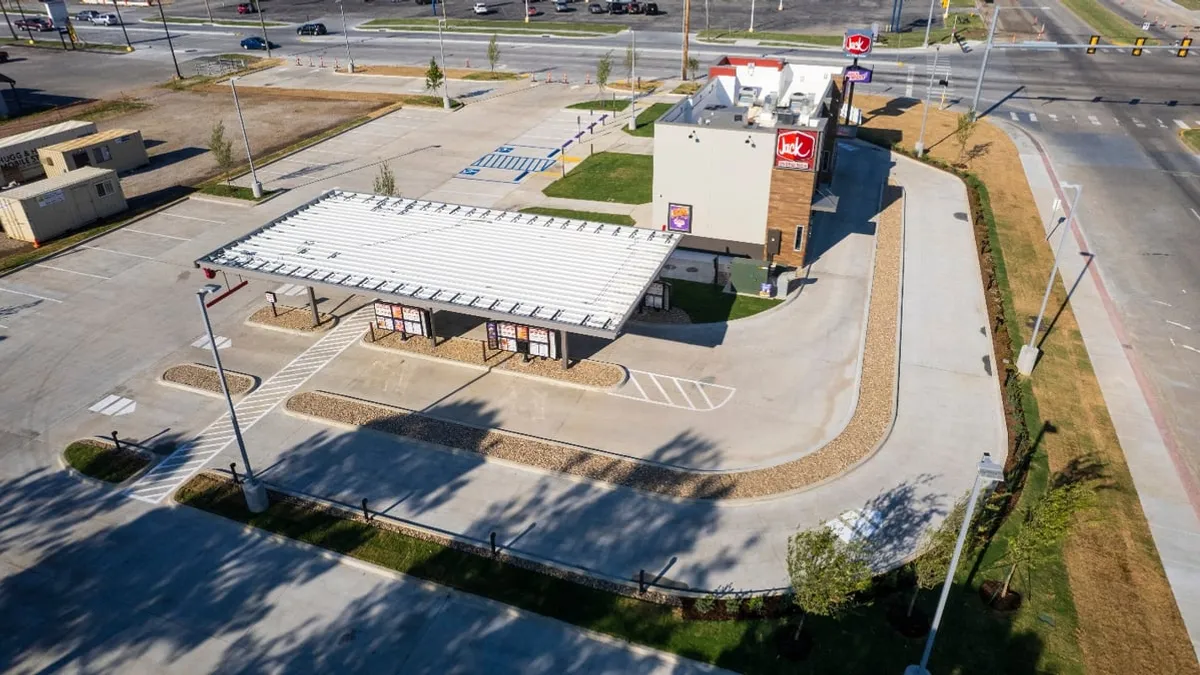 An image of a restaurant with two drive-thru lanes