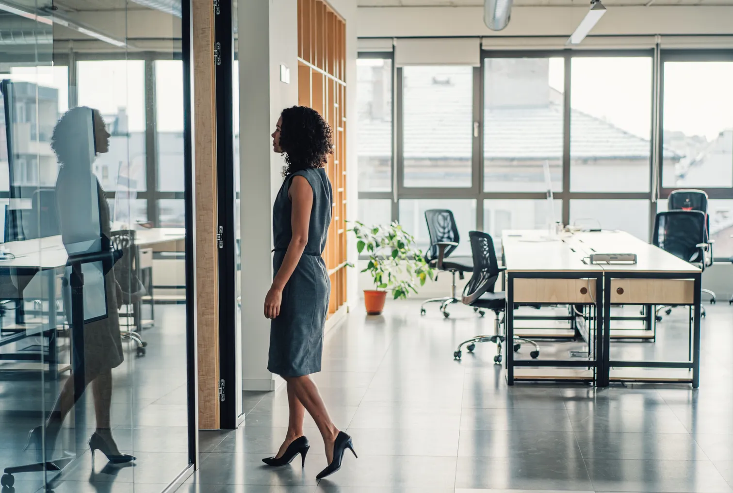 Businesswoman walking in modern office.