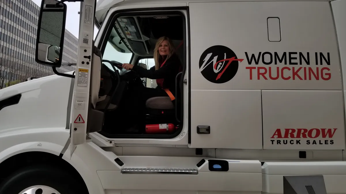 Women in Trucking President and CEO Ellen Voie in the driver's seat of a truck.