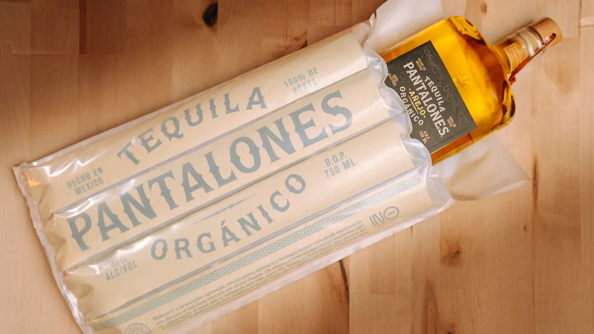 A bottle of Pantalones Tequila encased in protective packaging.