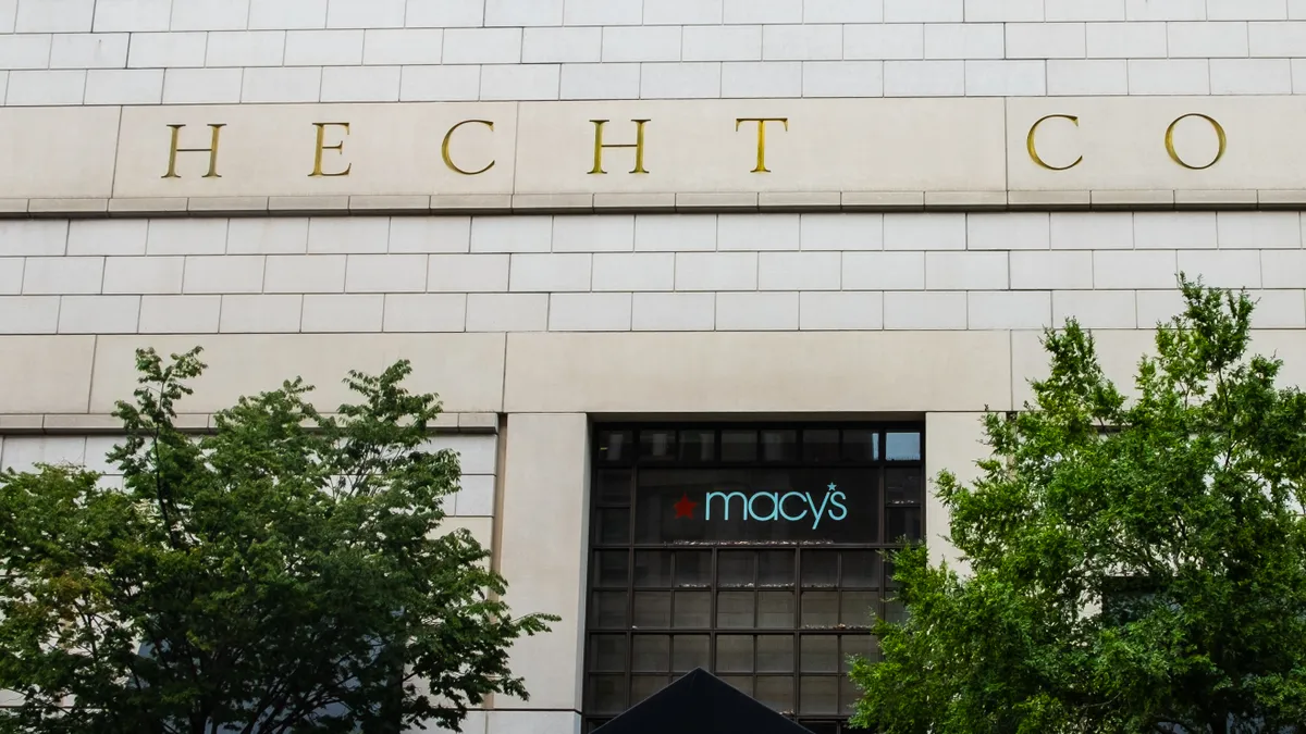 Two trees flank a Macy's entrance, with "Hecht Co." above in gold letters.