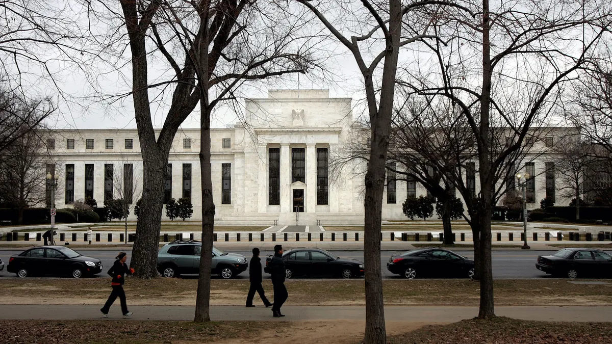 The Federal Reserve building is seen January 22, 2008 in Washington, DC. People walk by.