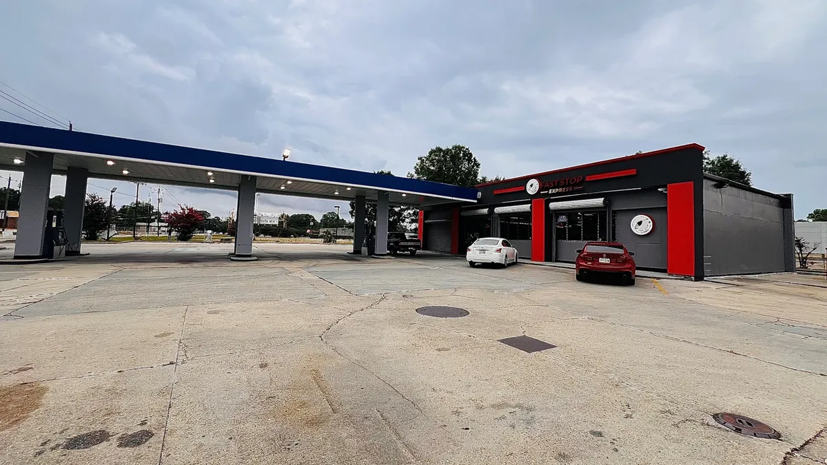 A photo of a gas station and convenience store. A sign above the store's door reads "Fast Stop Express."