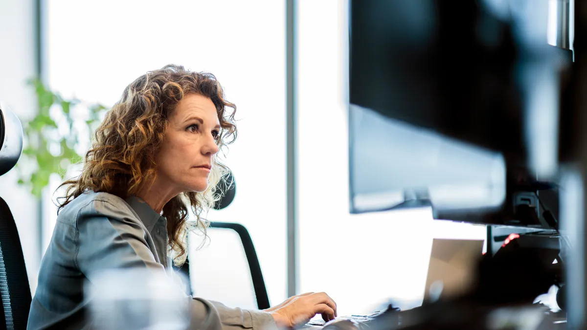 Female professional is sitting in office.