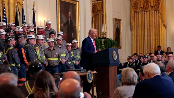 President Donald Trump speaks alongside coal and energy workers during an executive order signing ceremony.