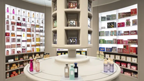A circular display of beauty products, with shelves of products in the background.