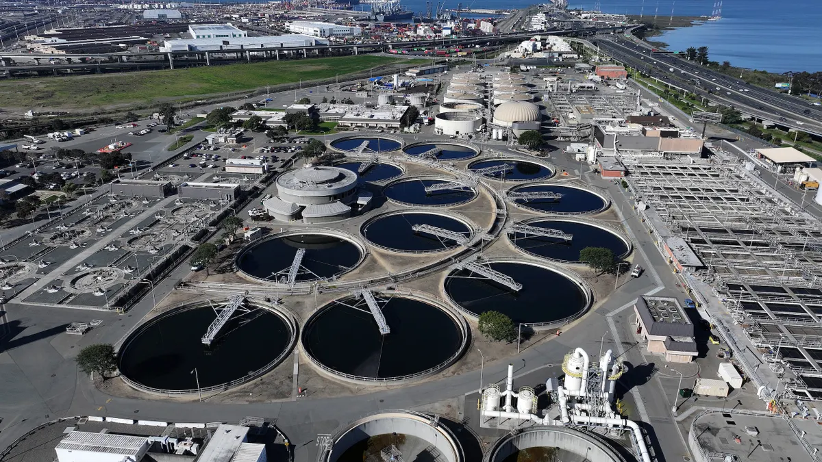 A sprawling water treatment plant on the shore of a large body of water.