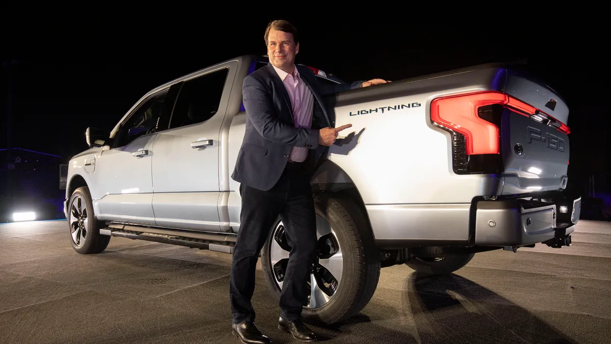 Jim Farley, CEO of Ford Motor Company, poses with the new all-electric F-150 Lightning performance truck.