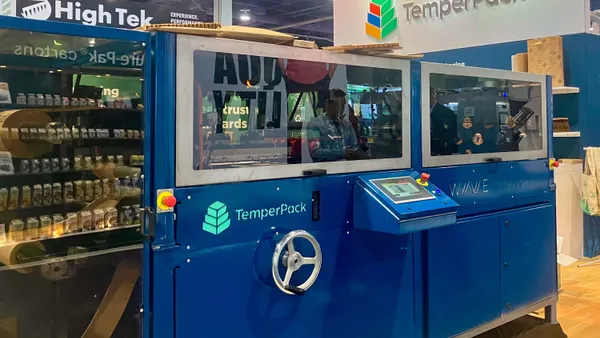 Equipment with branding for TemperPack is set up in an exposition hall.
