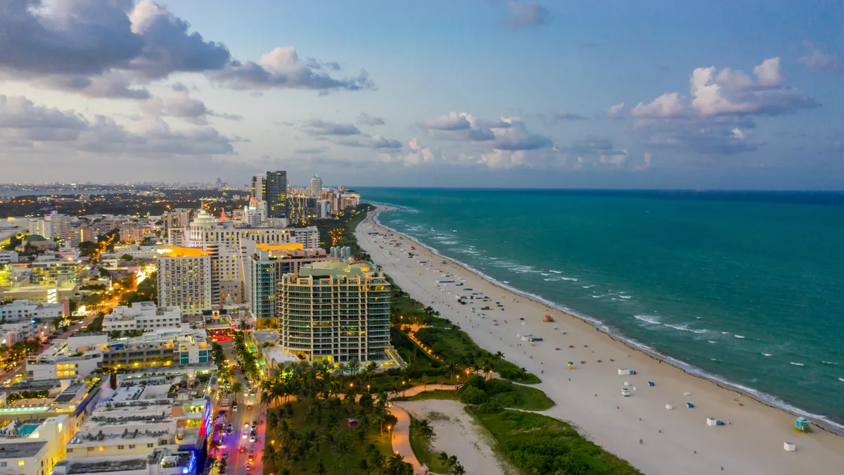 A north-facing view of Miami Beach's Ocean Drive with the ocean and condominiums.