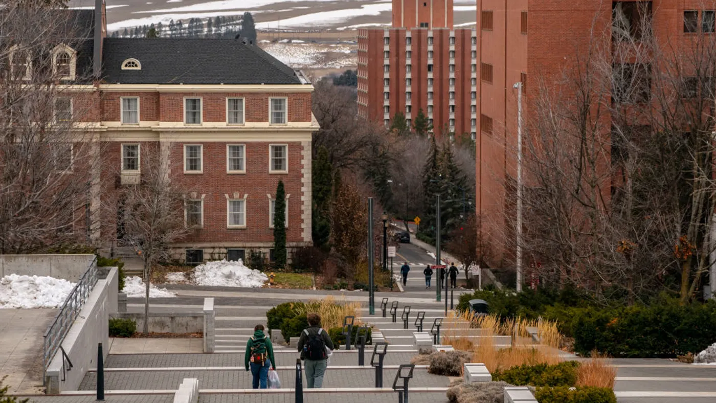Students walk on the Washington State University campus on a cloudy day.