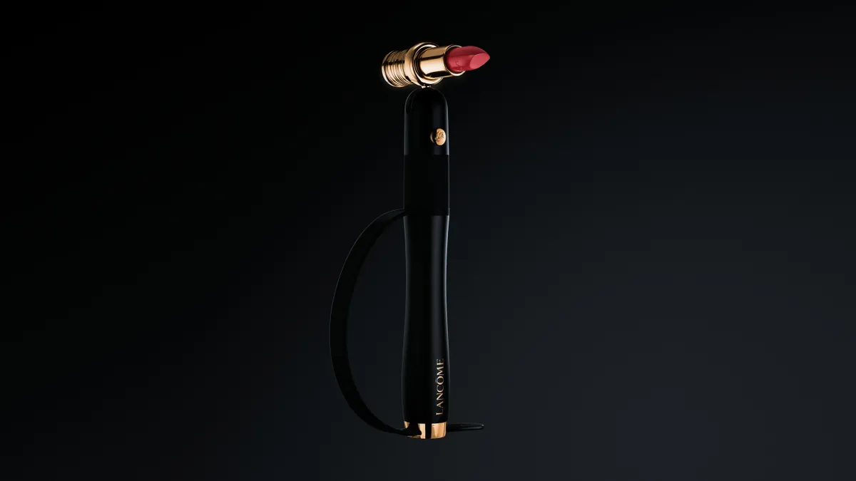 A black wand with red lipstick tube on top