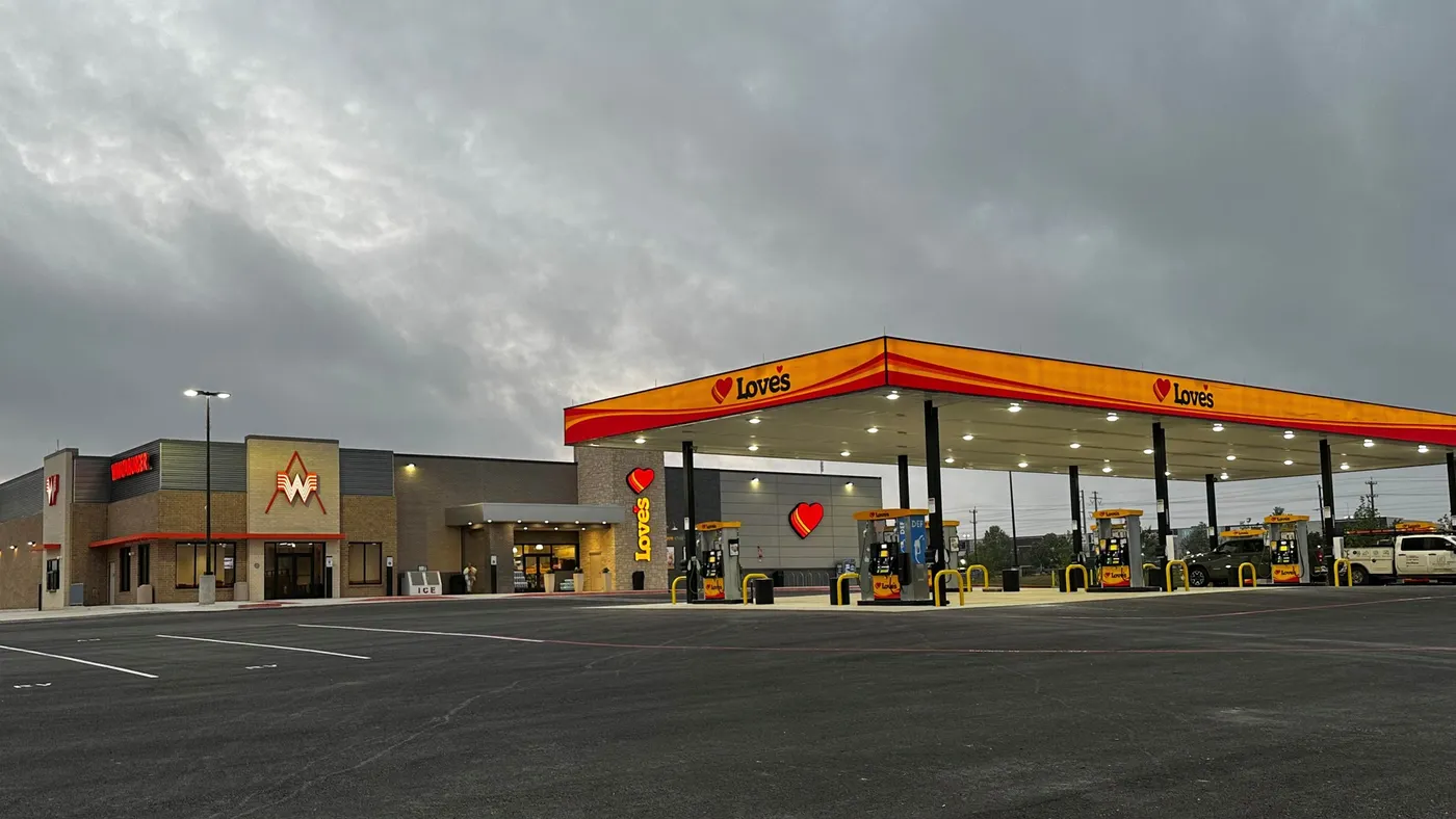 A photo of the exterior of a gas station and travel stop. Text on the fuel canopy says Love's and the building features the Love's and Whataburger logos.