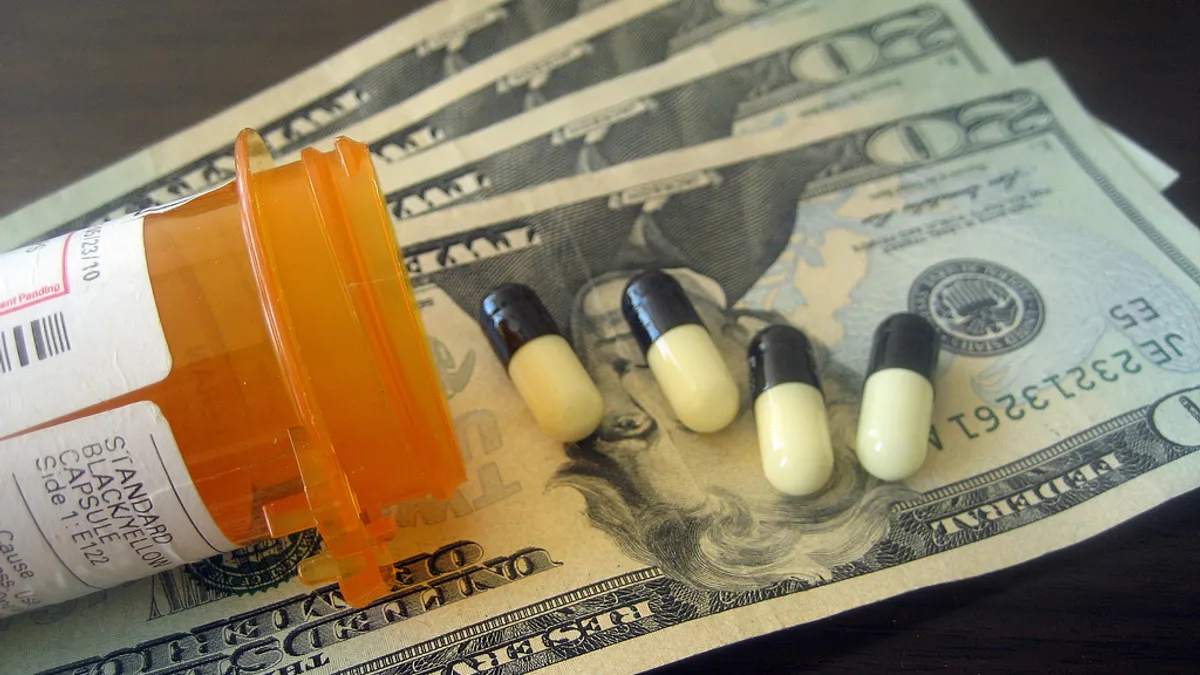 Black and white capsule pills on three 20 dollar bills.