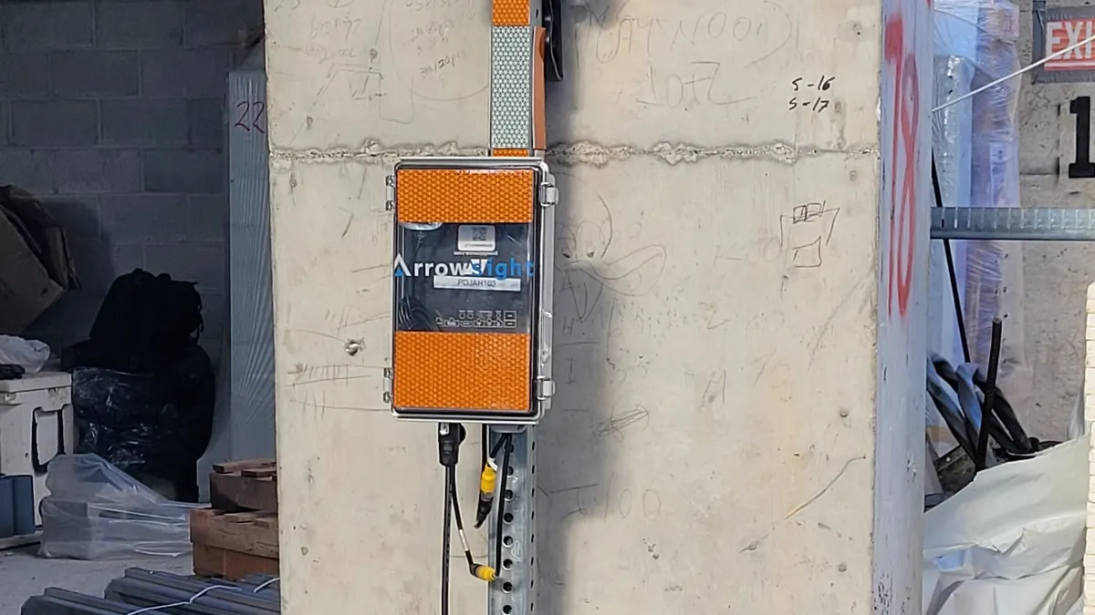 A camera system attached to a concrete column on a construction jobsite.