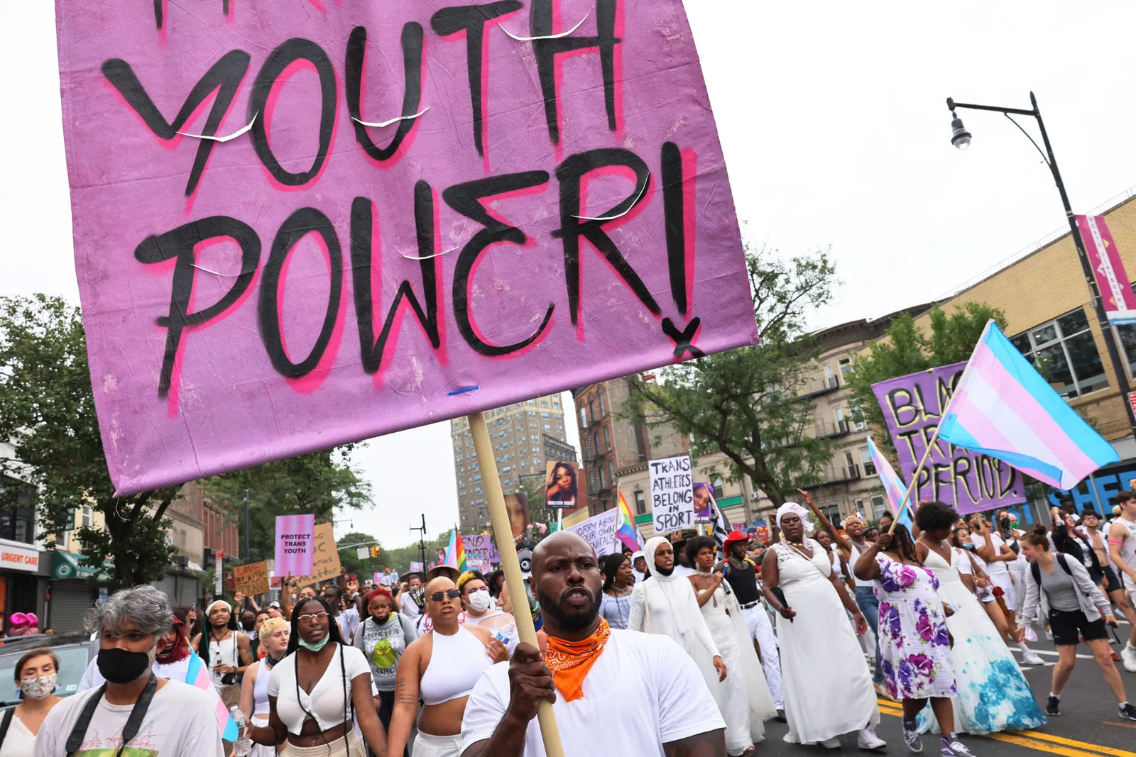 People protest in the street holding signs that read, "Youth Power."