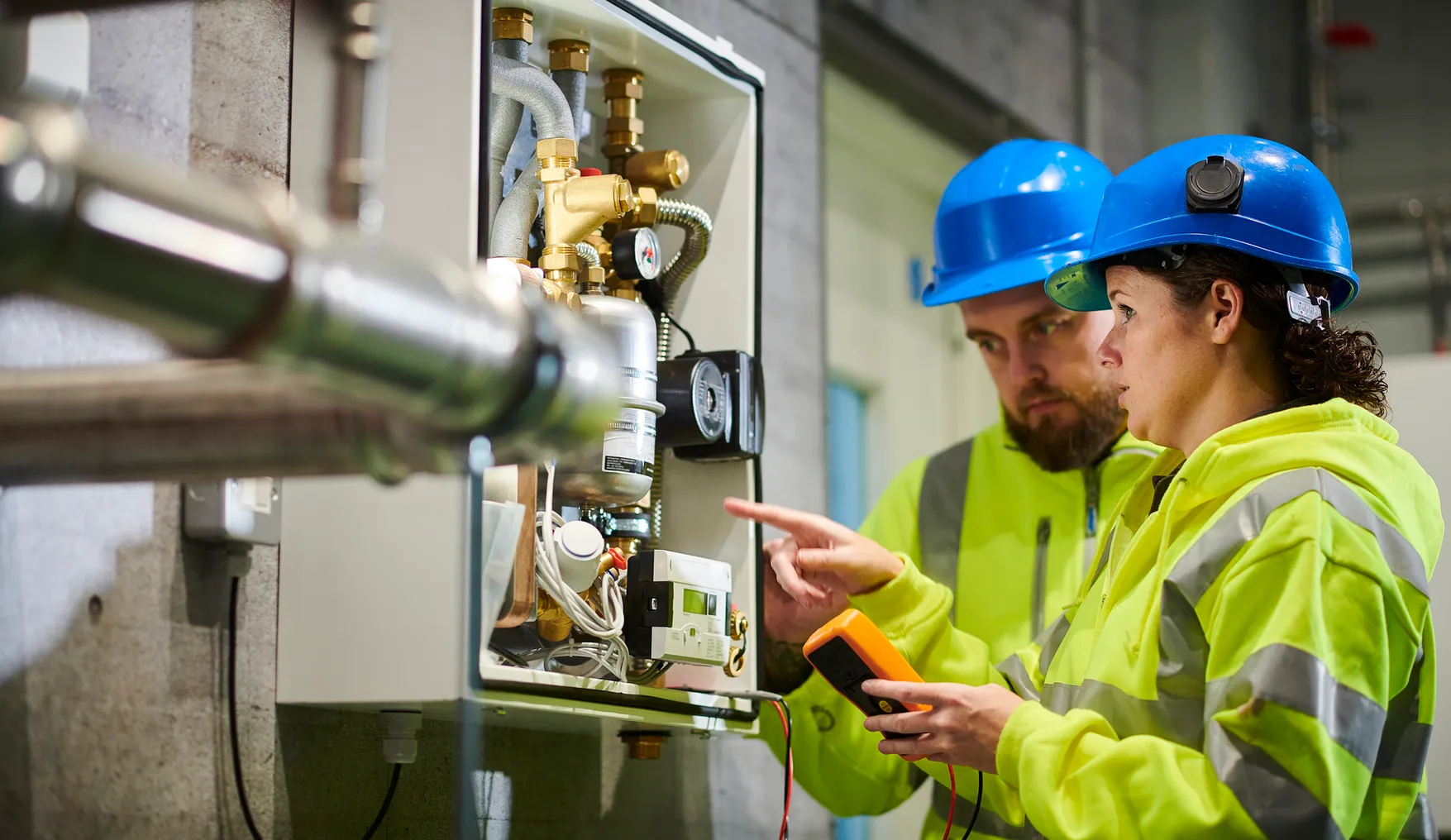 A technician trains another on a boiler.