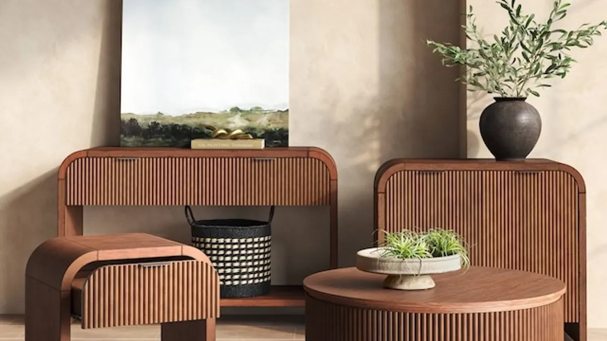 A room with wood furniture and decorationslike a painting and a vase of branches.