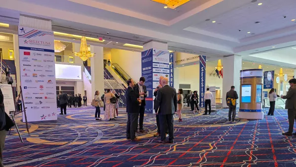 A group of people stand in the lobby of the 2026 SelectUSA Investment Summit