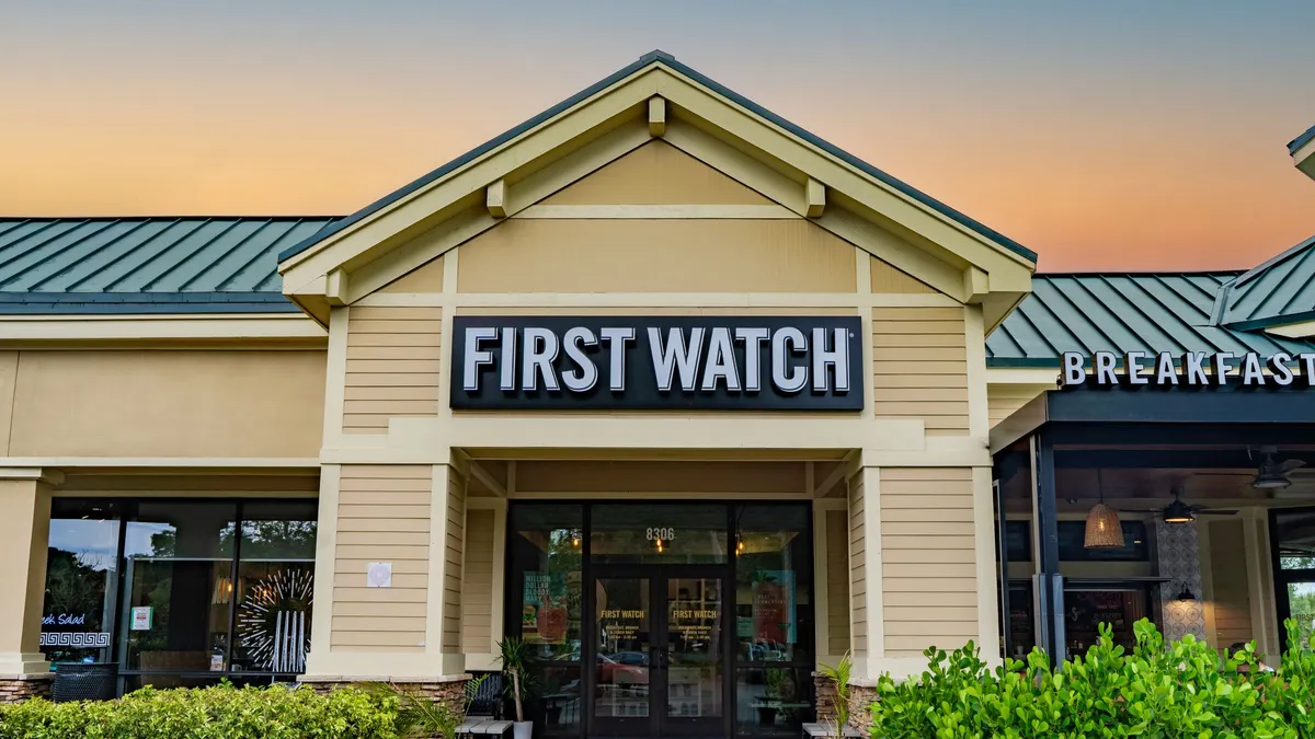 An image of a white building with First Watch signage