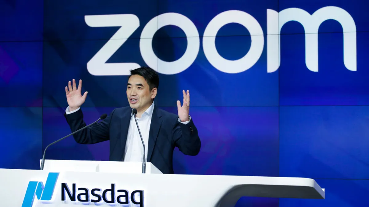 Zoom founder Eric Yuan speaking on a podium