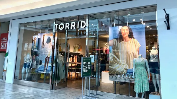 A mall entrance to a clothing store named "Torrid."