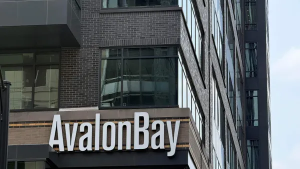 A picture of an AvalonBay sign in a modern brown building