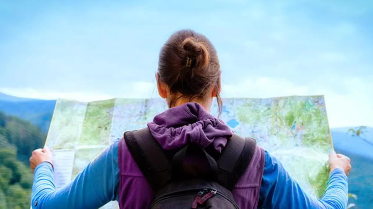 Girl looking at map outside