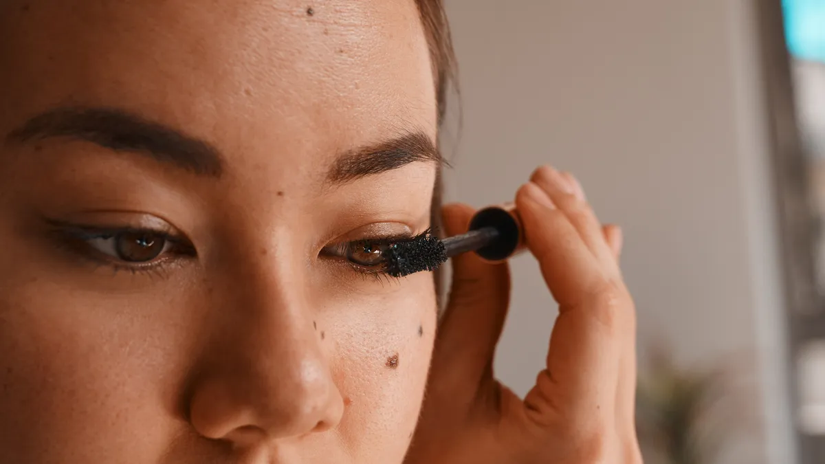 Shot of a person applying mascara during their beauty routine at home