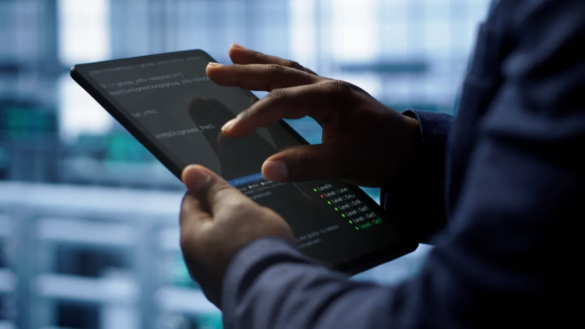 close up of a worker holding  up a tablet