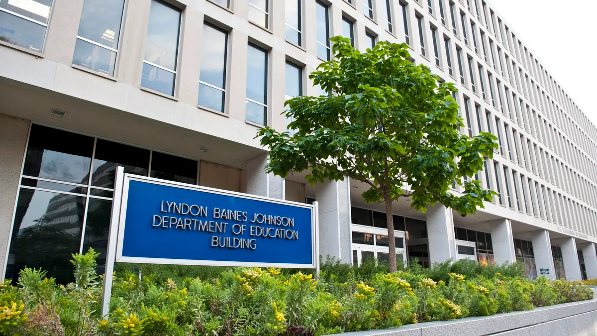 A wide shot of the Education Department building with a sign that reads Lyndon Baines Johnson Department of Education building.