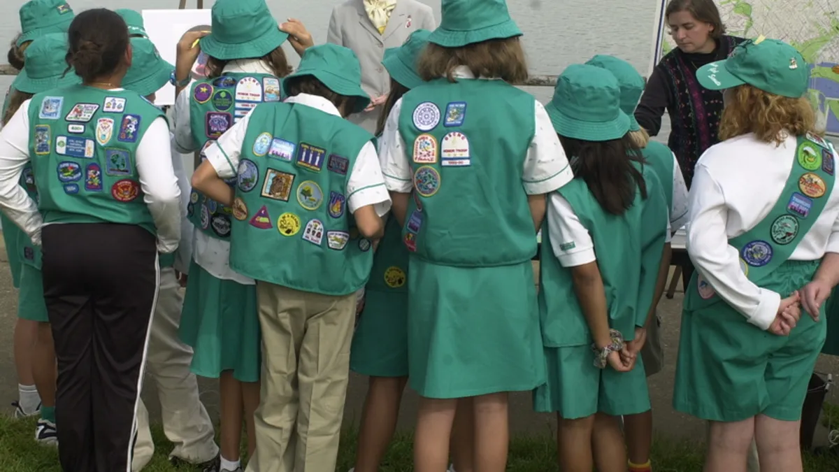 View of group of girl scouts from behind.