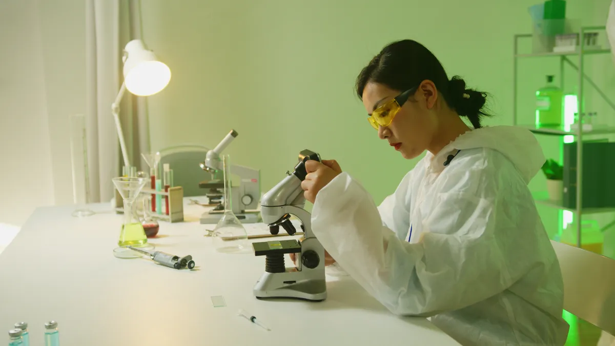 An Asian woman works on her project in a lab